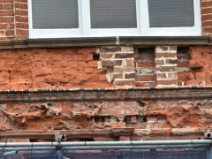 Site photo showing brickwork spalling and masonry decay beneath the window frame